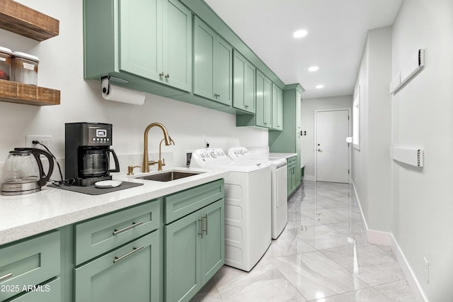 laundry room with washer and dryer, sink, and cabinets