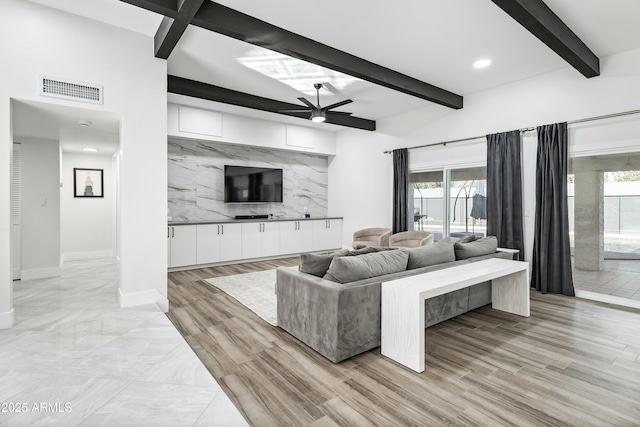 living room with ceiling fan and beam ceiling