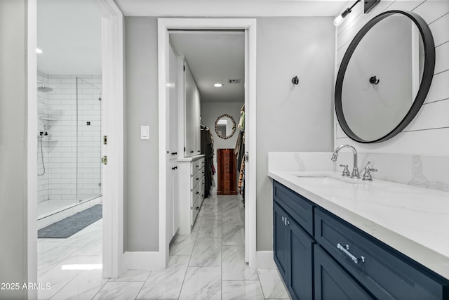 bathroom featuring vanity and a shower with door