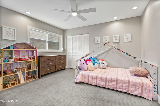 carpeted bedroom with ceiling fan and a closet