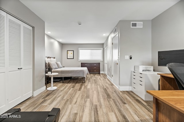 bedroom with a closet and light hardwood / wood-style flooring