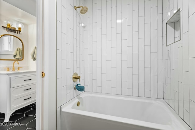 bathroom featuring tile patterned floors, tiled shower / bath combo, and vanity