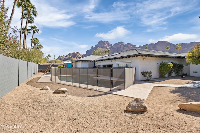 back of house with a patio area and a mountain view