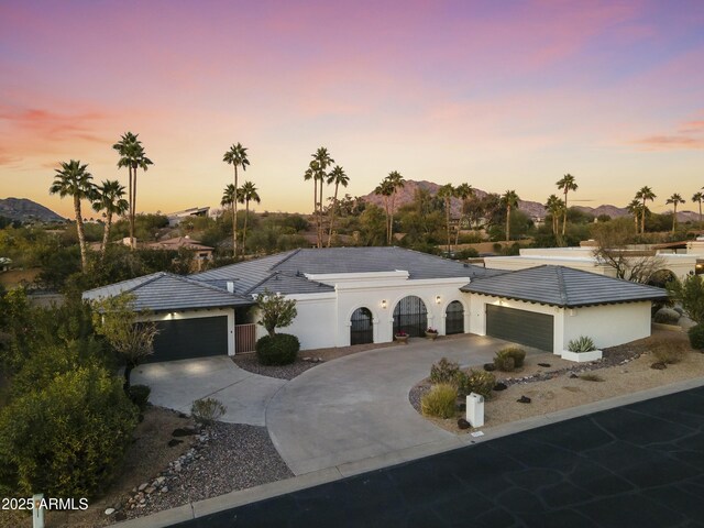 ranch-style house with a garage and a mountain view