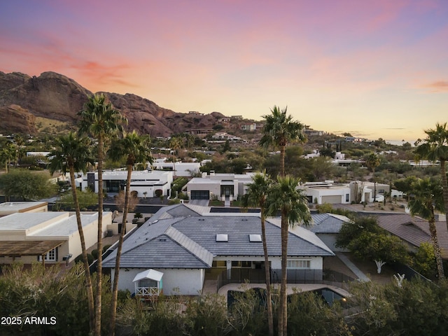 aerial view at dusk featuring a mountain view