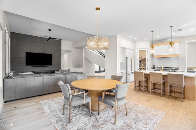 dining room featuring ceiling fan and light hardwood / wood-style flooring