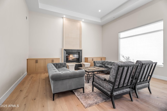 living room with light wood-type flooring and a fireplace