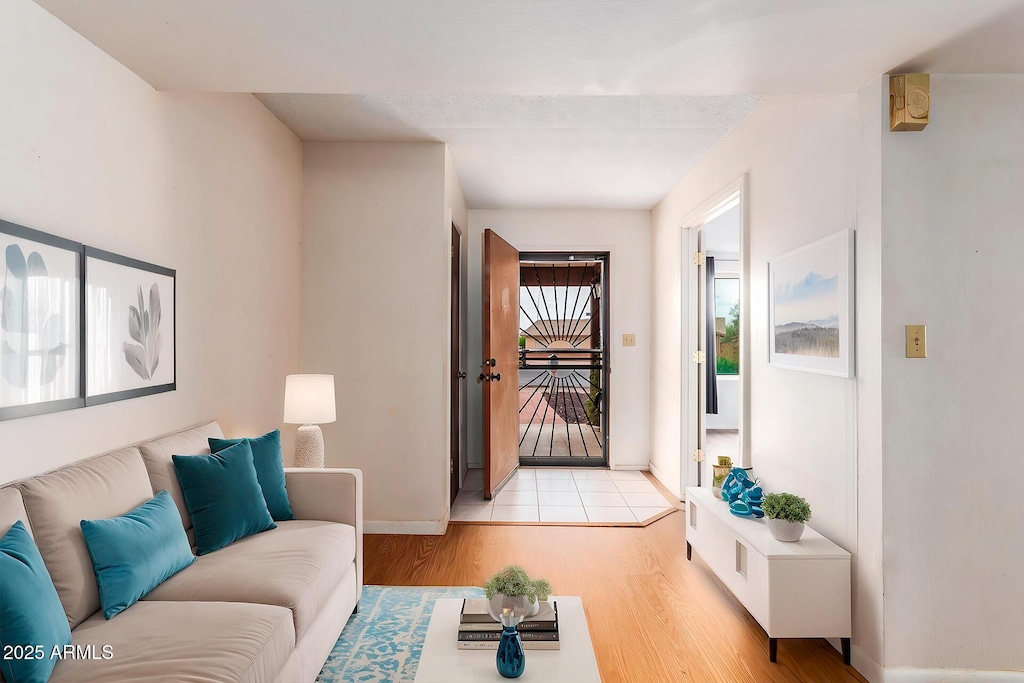 living room with light wood-type flooring and baseboards