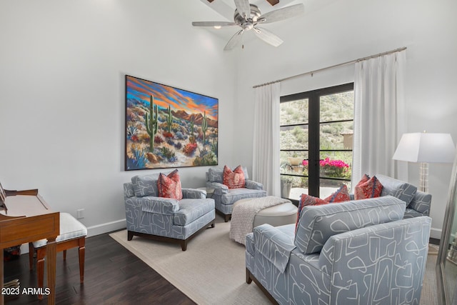 living room with dark hardwood / wood-style floors and ceiling fan