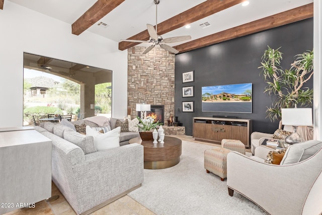 living room featuring ceiling fan, beam ceiling, and a fireplace