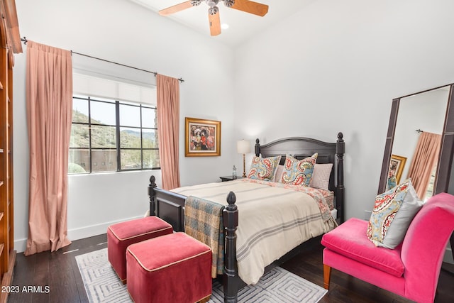 bedroom with dark hardwood / wood-style floors and ceiling fan