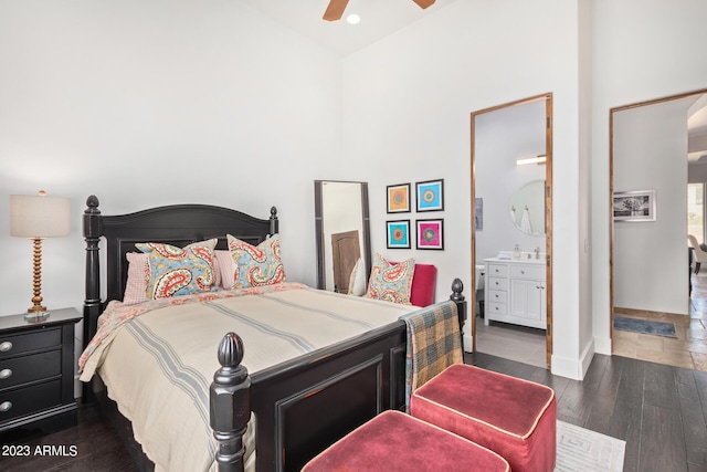 bedroom featuring dark hardwood / wood-style flooring, connected bathroom, and ceiling fan