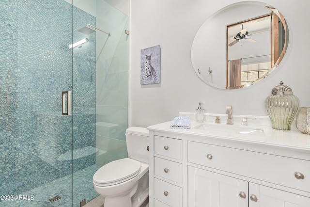 bathroom with an enclosed shower, vanity, toilet, and ceiling fan