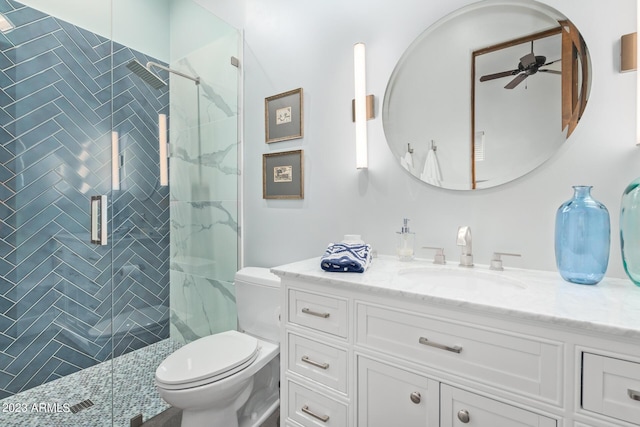 bathroom featuring walk in shower, ceiling fan, vanity, and toilet