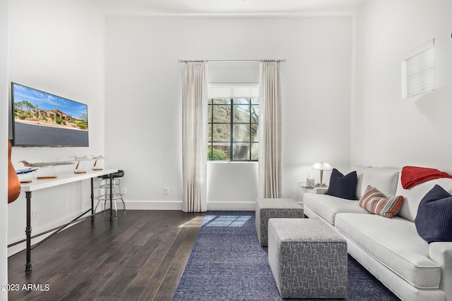 living room with baseboard heating and dark wood-type flooring