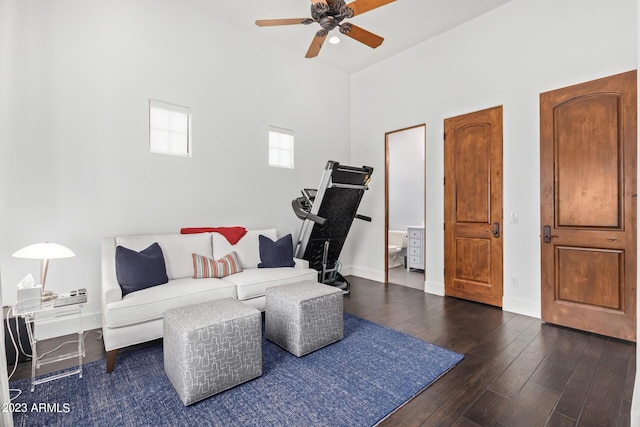 living room with ceiling fan and dark hardwood / wood-style floors