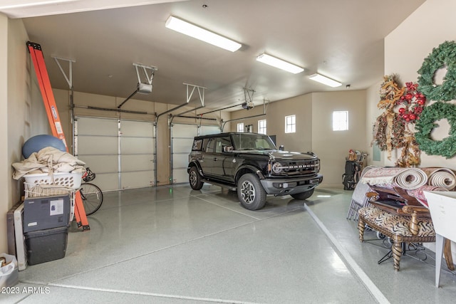 garage with a garage door opener and a carport