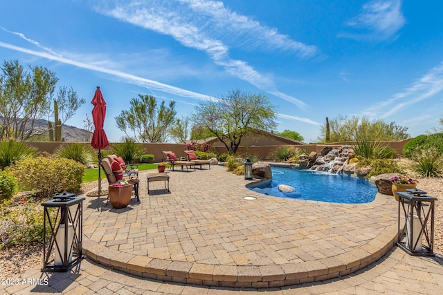 view of swimming pool featuring pool water feature and a patio