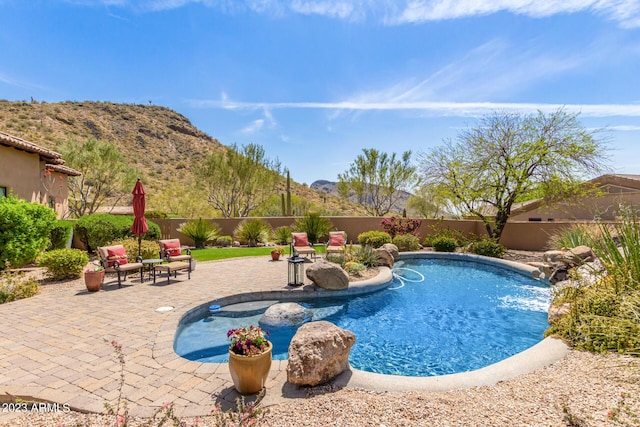 view of pool with a mountain view and a patio