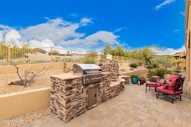 view of patio / terrace featuring a grill and exterior kitchen