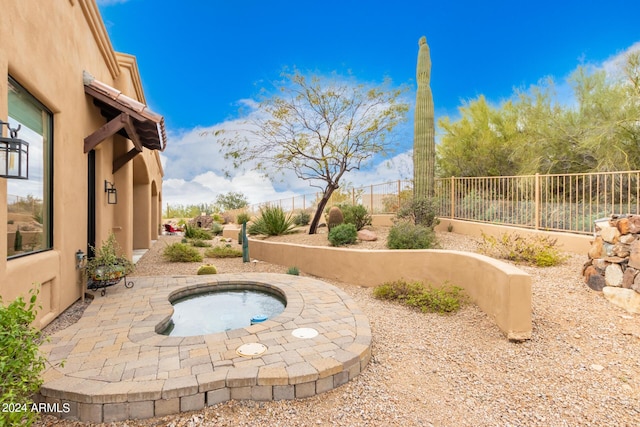 view of pool with a hot tub