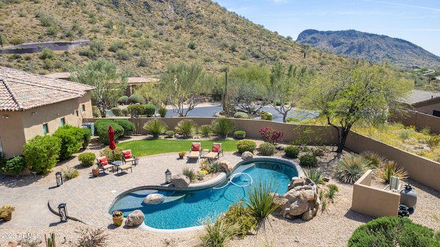 view of pool with a mountain view and a patio