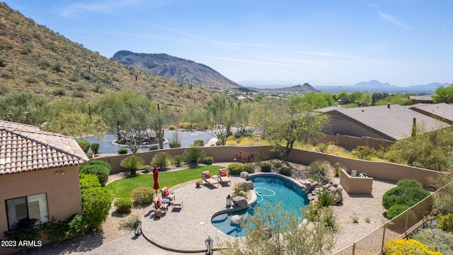 view of swimming pool featuring a mountain view and a patio area