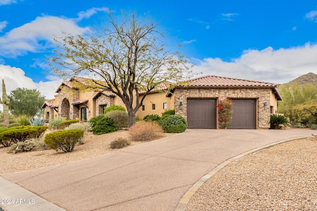 mediterranean / spanish house featuring a garage