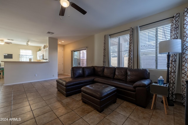 living room with tile patterned flooring, plenty of natural light, and ceiling fan