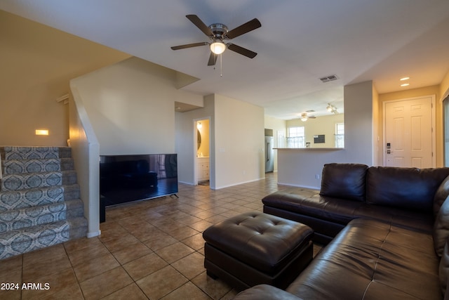 living room featuring tile patterned floors and ceiling fan