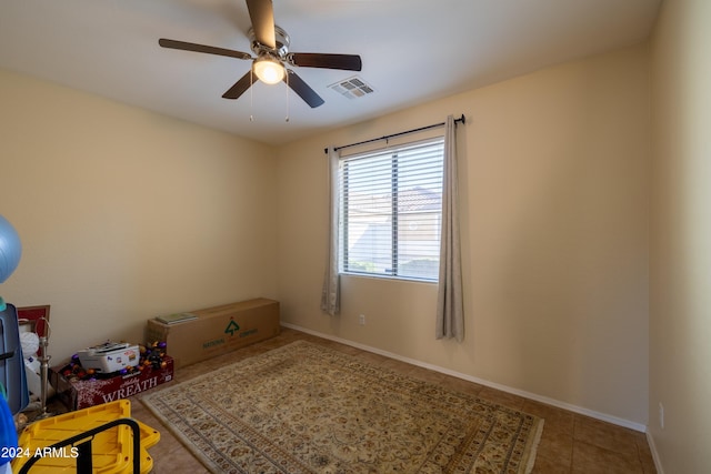 unfurnished room with tile patterned floors and ceiling fan