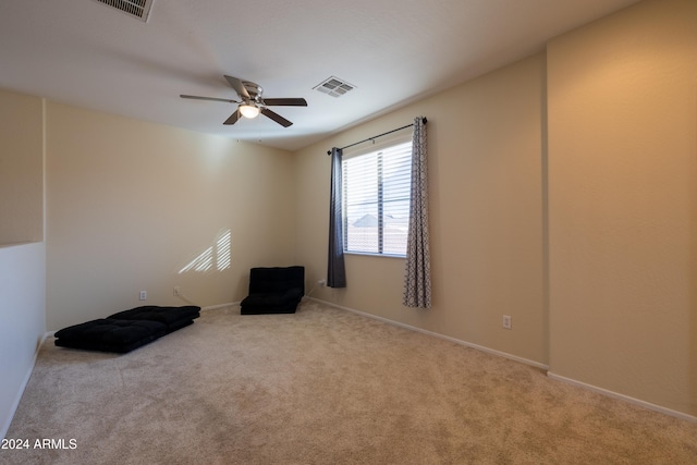 empty room featuring light carpet and ceiling fan