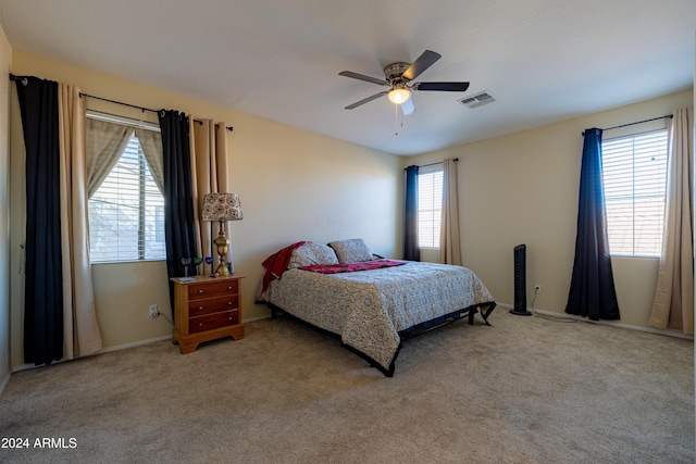 bedroom featuring ceiling fan and light carpet