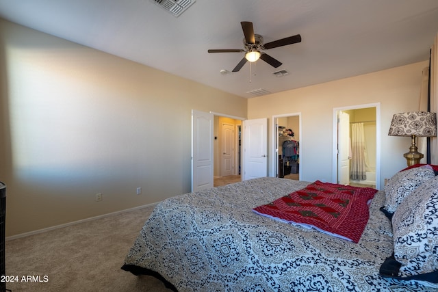 bedroom with ensuite bath, ceiling fan, a spacious closet, carpet floors, and a closet