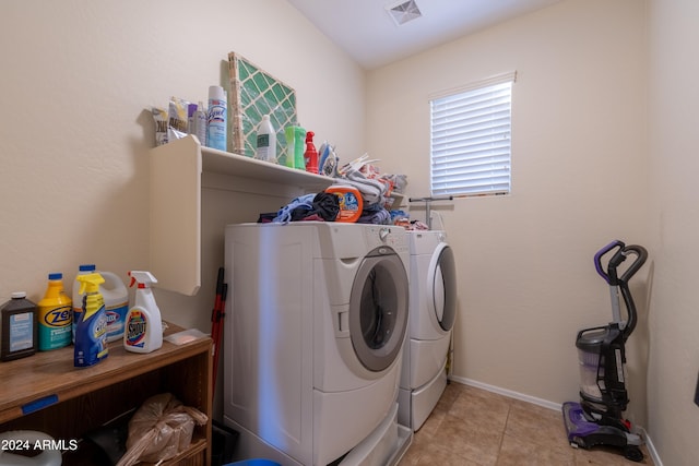 laundry room with light tile patterned floors and washing machine and clothes dryer