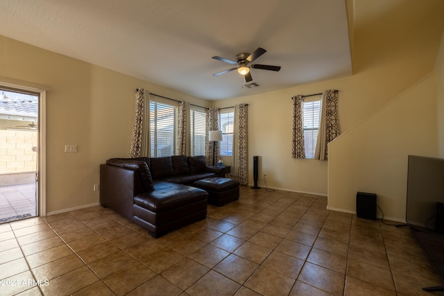 living room with tile patterned floors, a wealth of natural light, and ceiling fan