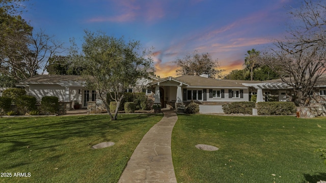 view of front of house featuring a yard and a pergola