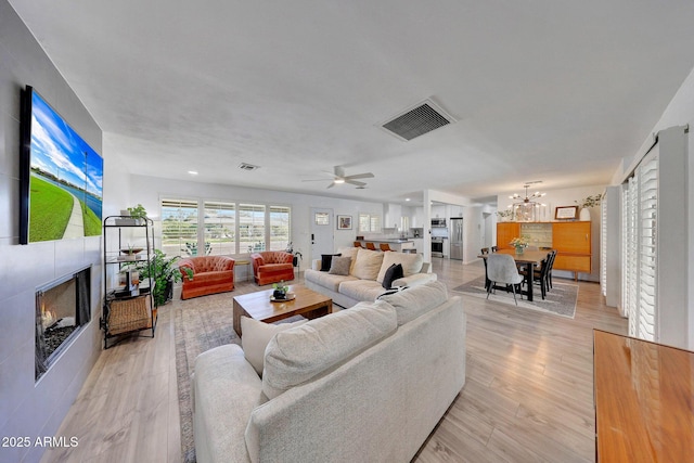 living room featuring an inviting chandelier and light hardwood / wood-style flooring