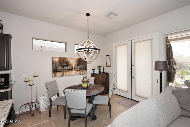 6937 E Purple Shade Cir, Scottsdale, AZ 85266 - dining room with a chandelier, light tile patterned floors, and baseboards