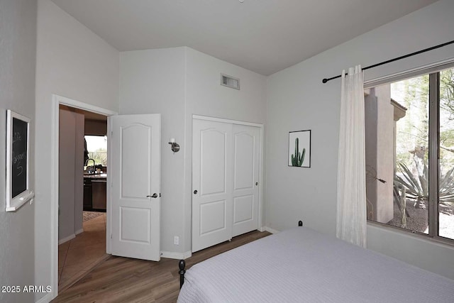 6937 E Purple Shade Cir, Scottsdale, AZ 85266 - bedroom featuring wood finished floors, baseboards, a closet, and a sink