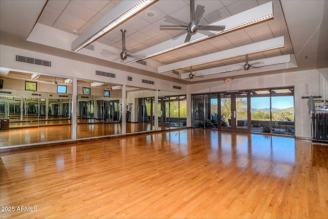 6937 E Purple Shade Cir, Scottsdale, AZ 85266 - exercise area with a ceiling fan, wood finished floors, and a high ceiling