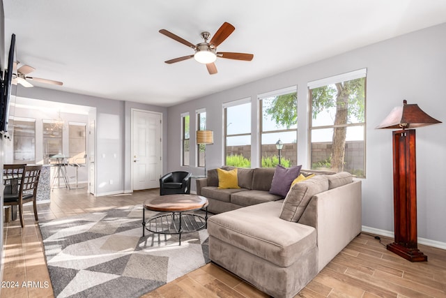 living room featuring light hardwood / wood-style flooring and ceiling fan