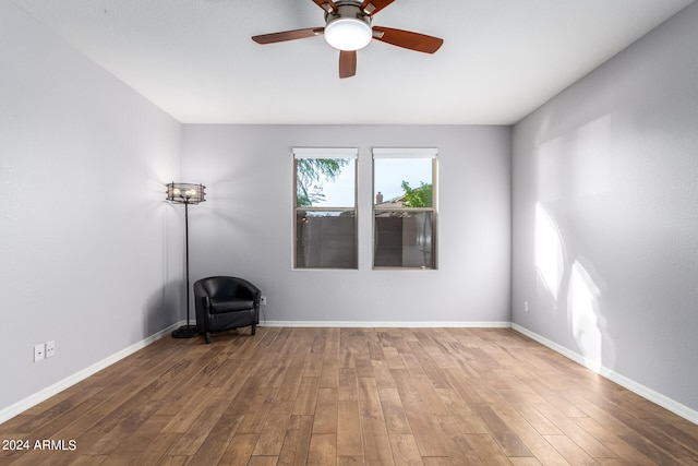 empty room with ceiling fan and wood-type flooring