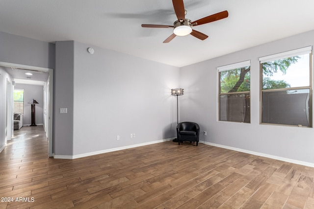 spare room with ceiling fan and hardwood / wood-style flooring