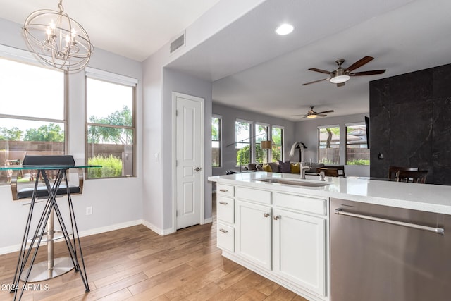 kitchen featuring ceiling fan with notable chandelier, dishwasher, light hardwood / wood-style flooring, sink, and white cabinets