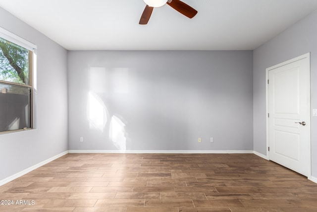 unfurnished room with ceiling fan and hardwood / wood-style flooring