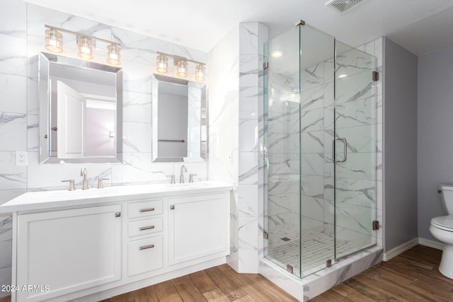 bathroom with vanity, toilet, wood-type flooring, and walk in shower