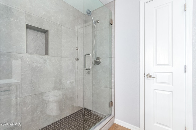 bathroom featuring a shower with shower door