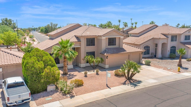981 N Quail Ln, Gilbert, AZ 85233 - mediterranean / spanish-style house featuring a tiled roof, concrete driveway, stucco siding, and a garage