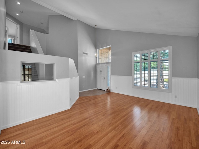 981 N Quail Ln, Gilbert, AZ 85233 - unfurnished living room with wainscoting, wood finished floors, and high vaulted ceiling